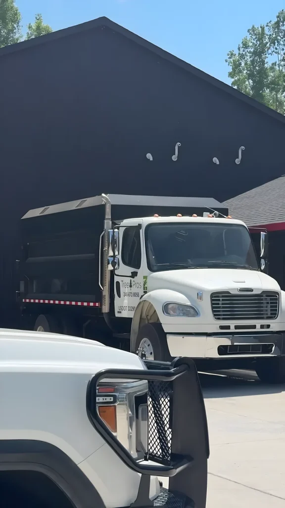 Tree Pros chip truck and pickup parked at the shop in Bloomfield Township